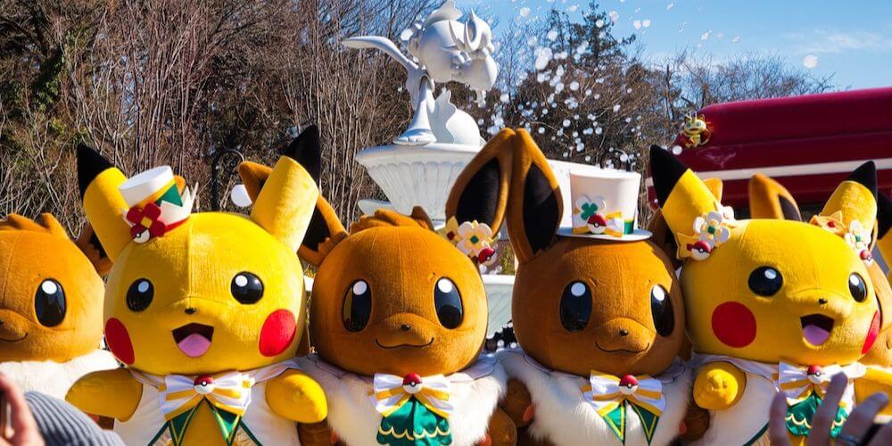A group of costumed Pikachus and Eevees performing in the parade at PokePark KANTO Yomiuri Land.